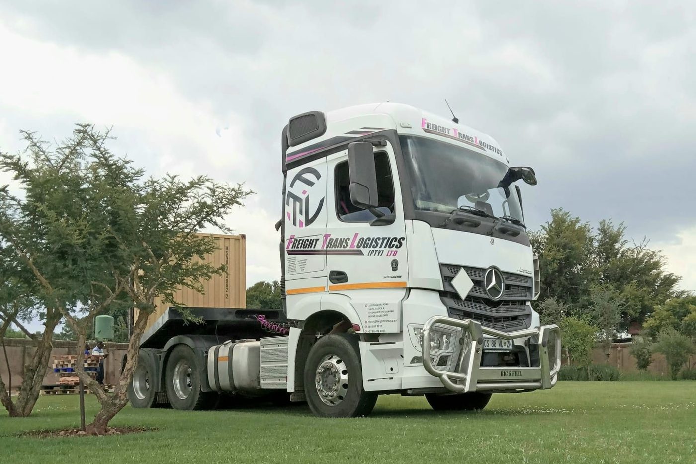 Freight Trans Logistics Actros 2645 horse parked alongside a shipping container